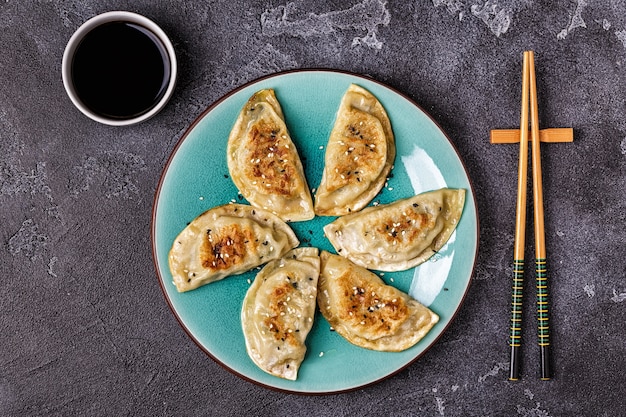 Close view on dumpling snacks with chopsticks