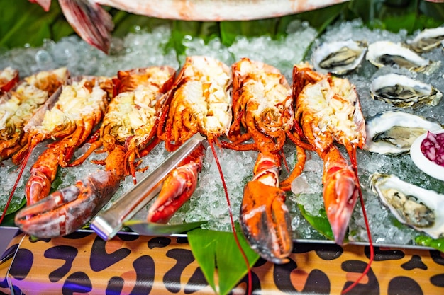 A close view of lobsters and oysters on ice An exotic meal of tasty cooked lobsters Closeup