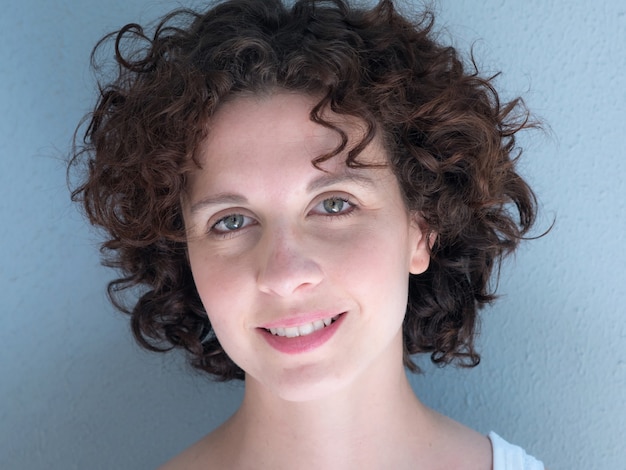 Close of Young Brazilian woman smiling to the camera .