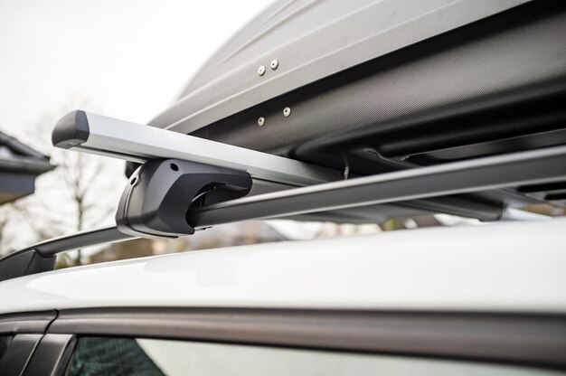 Closed assembled trunk or cargo box on the roof of the car before a family vacation