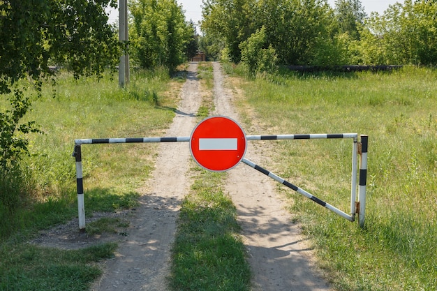 Closed barrier and prohibition sign on a rural road no entry