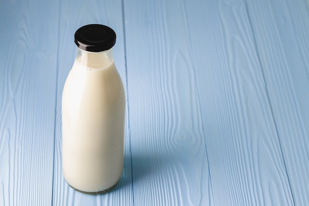 Closed blank glass bottle of milk, front view