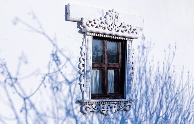 Closed blue window blinds at stone house