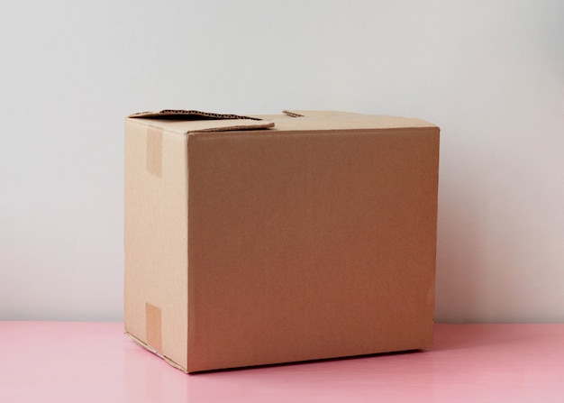 A closed cardboard box stands on a white background the concept of parcel and delivery