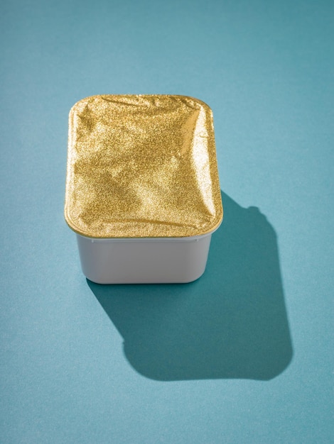 Closed container with food on a blue background