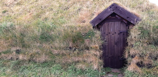 Photo closed door of hut on field