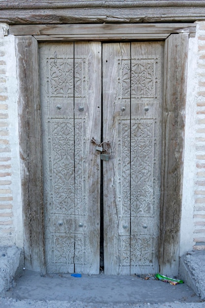 a closed door in a old home in uzbekistan
