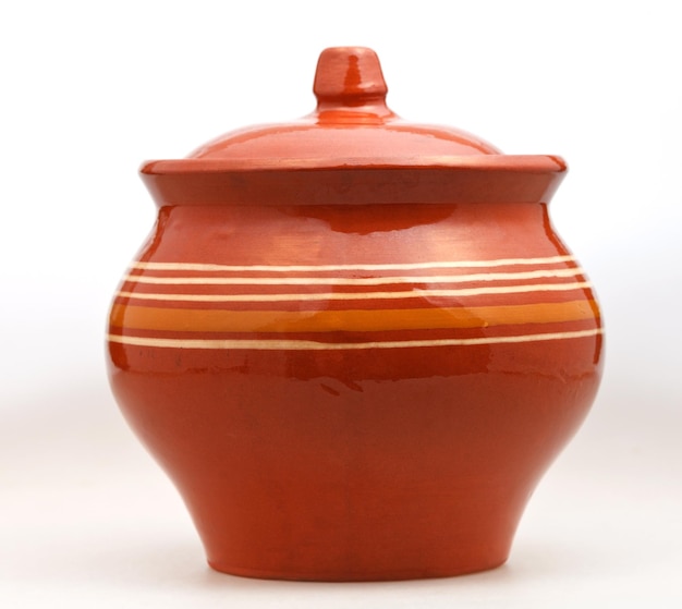 Closed earthenware pot on white