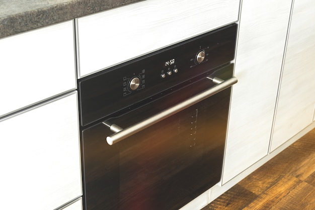 Foto forno elettrico chiuso nella foto del fondo di progettazione della cucina interna in legno moderna