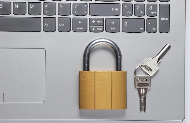 Closed lock and keys on a laptop keyboard