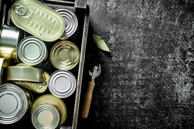 Photo closed metal cans with canned food in the box