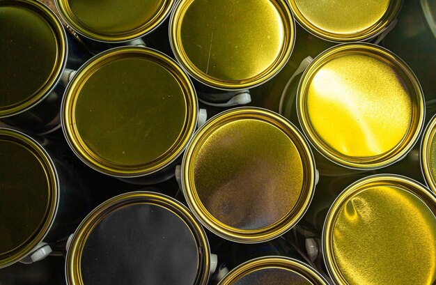 Closed new paint cans with golden lids closeup