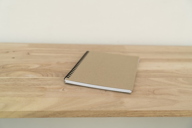 Closed notebook on wooden table