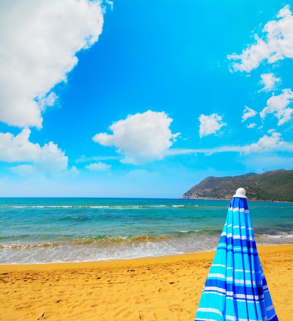 Closed parasol in Porto Ferro beach Sardinia