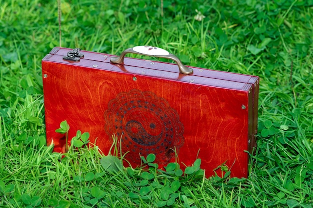 closed portable folding yoga board with nails stands on the grass