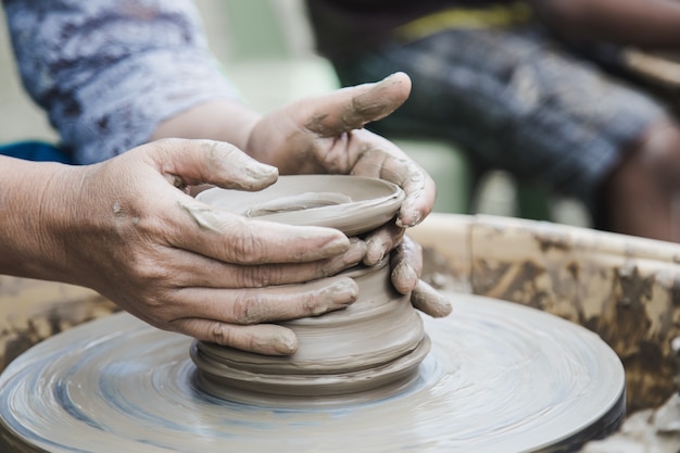 Closed up hands man using mechanic pottery 