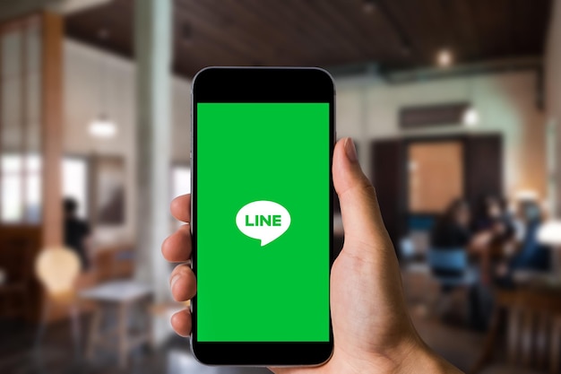 Closed up image of a female using line application on a\
smartphone in cafe