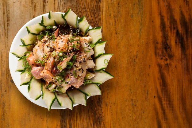 Closed up of Japanese Dish : a big bowl of rice mixed with fresh fish (salmon and other fish) on top called "Chirashi" .