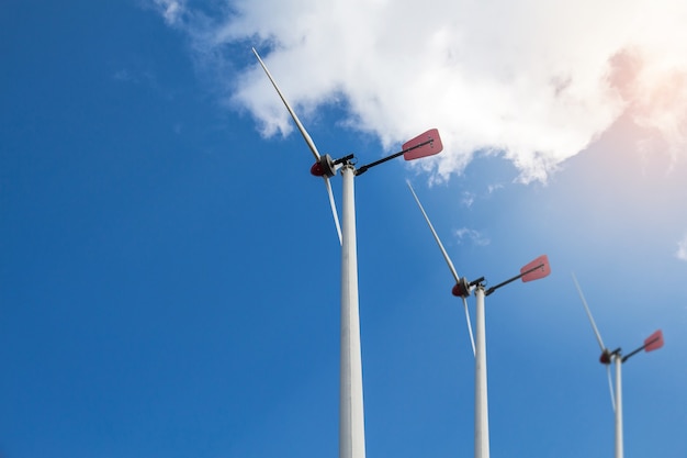 Closed up Wind turbine generating electricity on blue sky with clounds