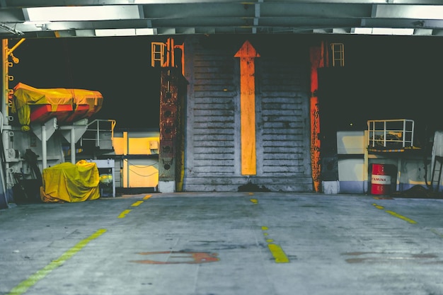 Photo closed wearhouse gate with yellow arrow up sign with empty floor