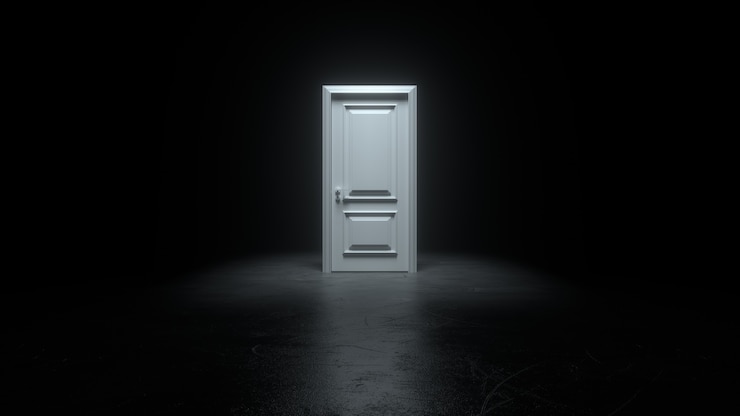 Photo closed white door in a dark room with bright light