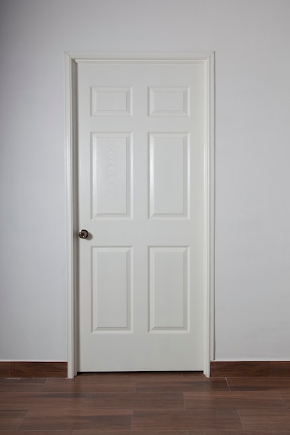 closed white door on gray wall