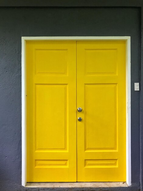 Closed yellow door of house