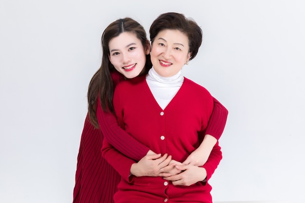 Closeness of mother and daughter isolated on white