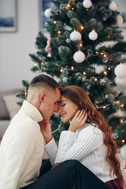 closeness of the people young romantic couple celebrates new year together indoors