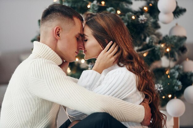 closeness of the people young romantic couple celebrates new year together indoors