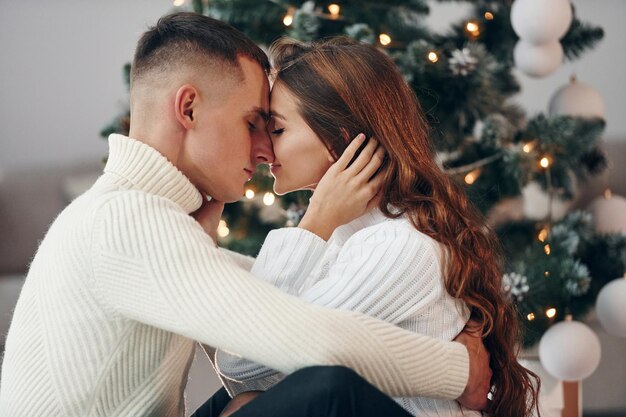 Closeness of the people Young romantic couple celebrates New year together indoors