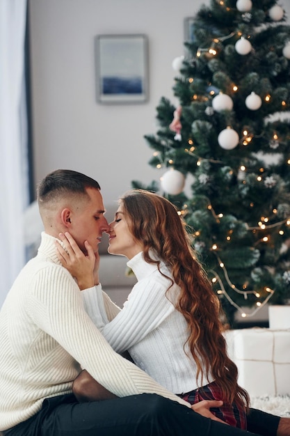 Closeness of the people Young romantic couple celebrates New year together indoors