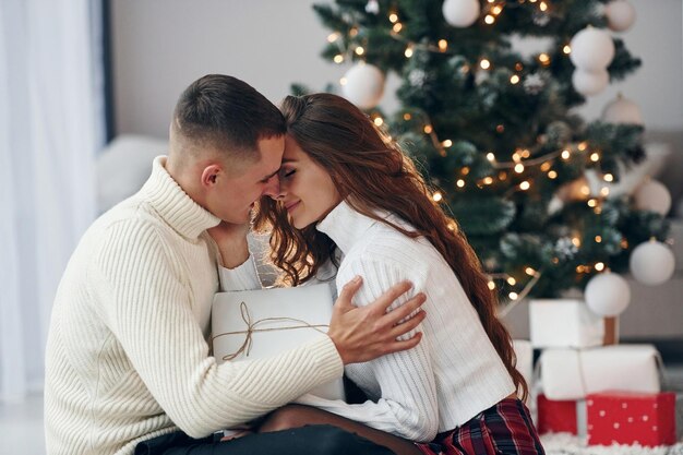 Closeness of the people Young romantic couple celebrates New year together indoors