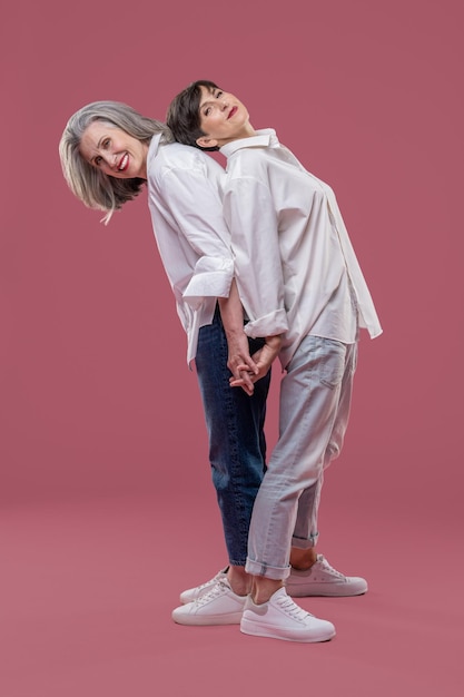 Closeness. Two women standing back to back and feeling close