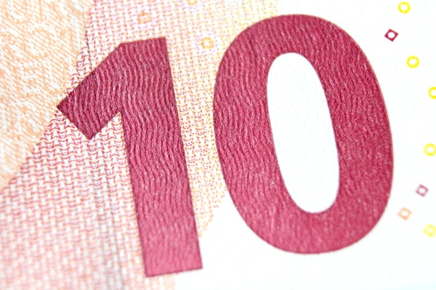 Photo closeup of a 10 euro banknote fragment on the reverse side showing the denomination number 10