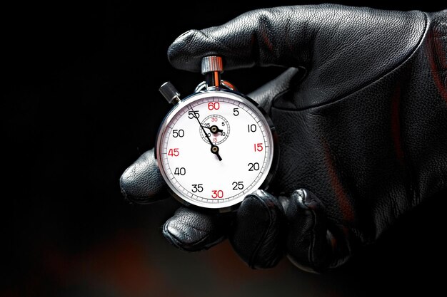 CloseUp 4K Ultra HD Image of Stopwatch in Hand with Black Glove