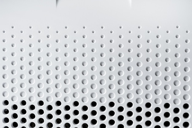 Closeup of abstract hi-tech background plastic surface with a holes and circles