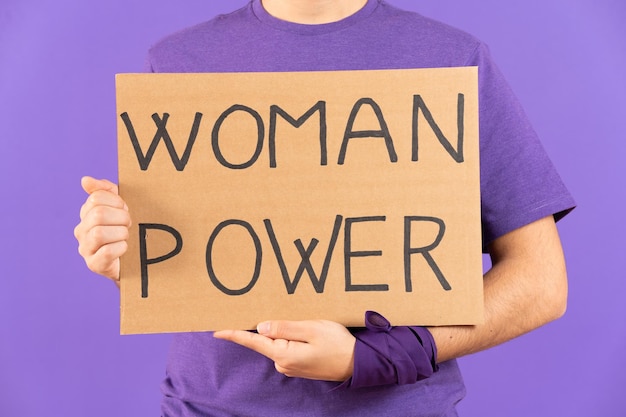 Closeup of activist holding billboard with woman power message