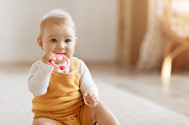 Photo closeup of adorable little baby boy sitting on floor