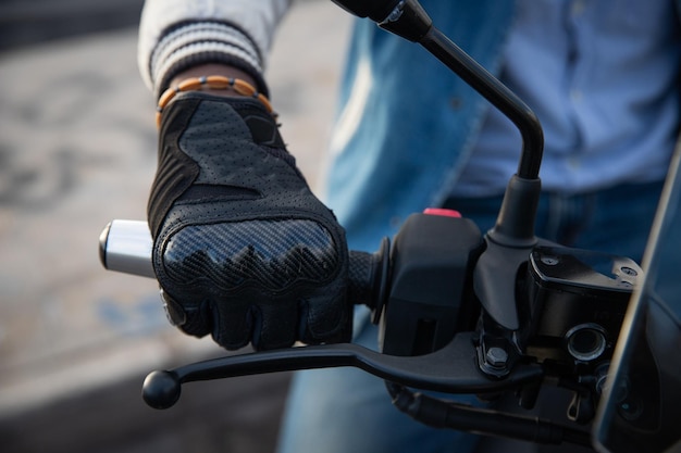 Closeup of an african biker's hand holding the handlebars of his motorcycle