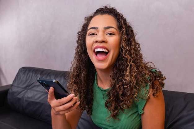 Closeup of afro woman using cell phone.