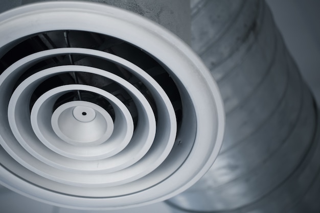 closeup air hole grill of interior air duct of cooling air conditioners metal pipe in the building.