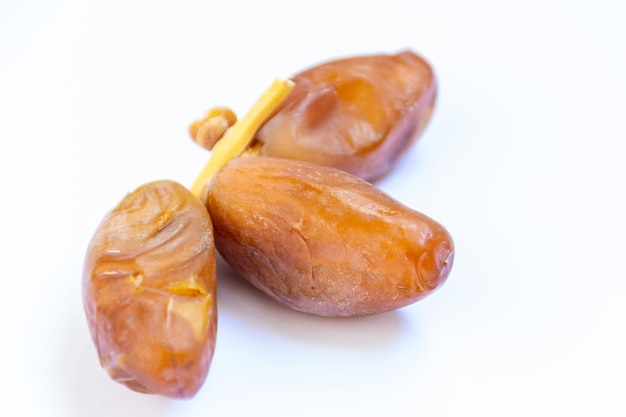 Closeup of Algerian royal dates on a white background Ramadan concept Delicious fruit
