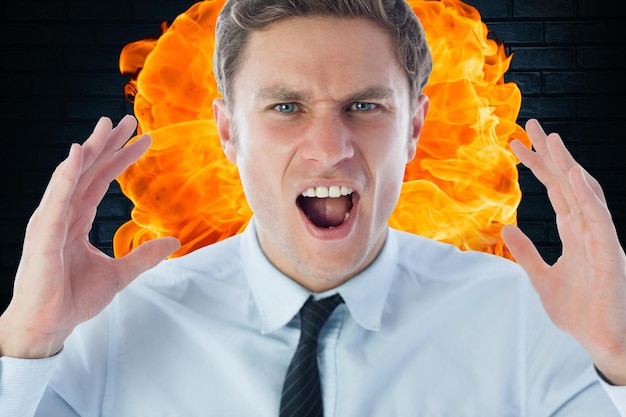 Closeup of angry businessman shouting against fire