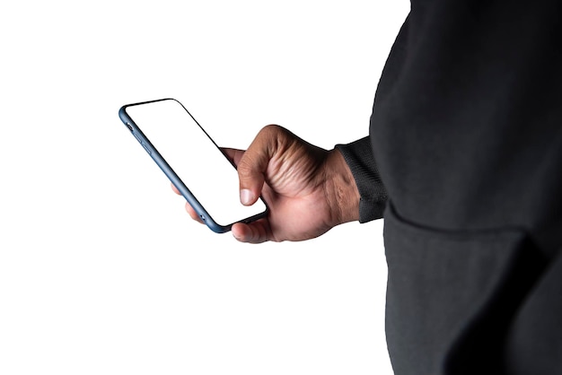 CloseUp An anonymous hacker wearing a mask and a black hoodie shows off a smartphone with a blank white screen with clipping path Hacking and Malware Concepts