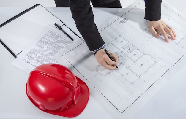 Closeup of architects hands revising a house project plans