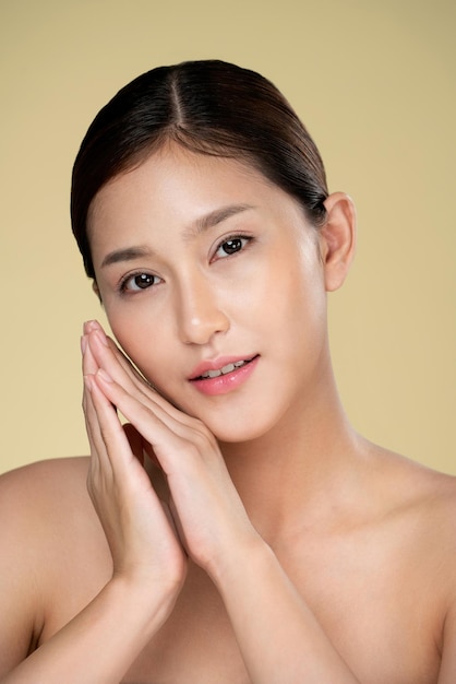 Closeup ardent young woman posing beauty gesture with clean fresh skin