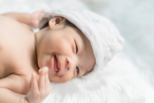 Closeup asian baby is smiling on the carpet wool