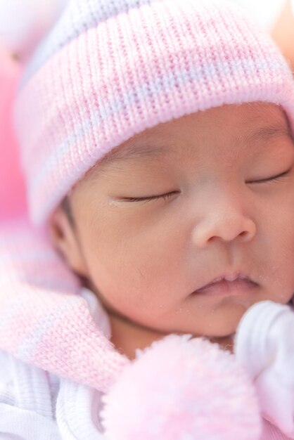 Closeup asian baby sleeping In the embrace of mother