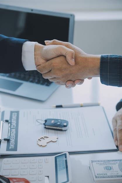 Closeup asian male people car salesman or sales manager offers to sell a car and explains and reads the terms of signing a car contract and insurance